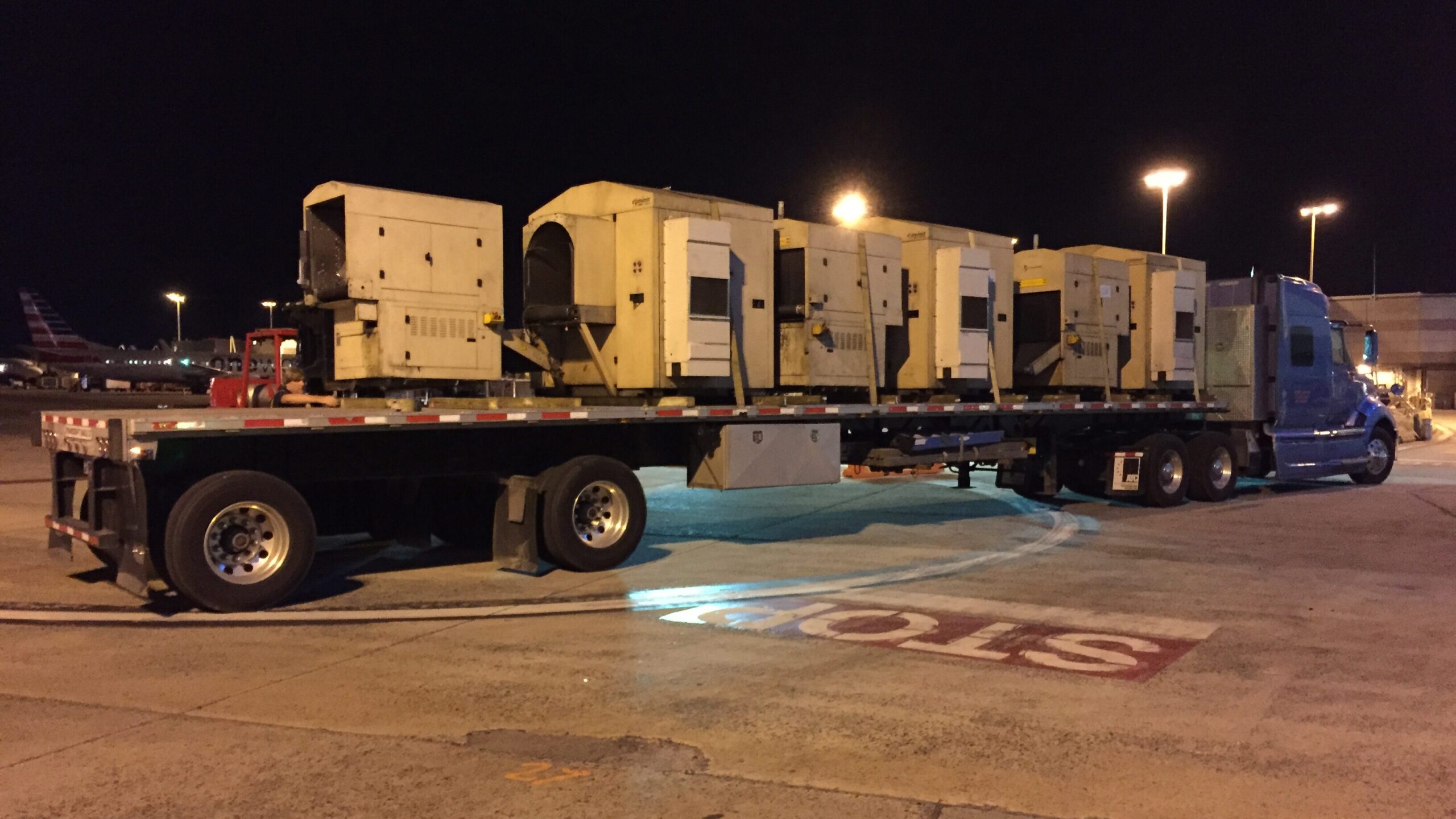 Equipment transport truck at airport at night